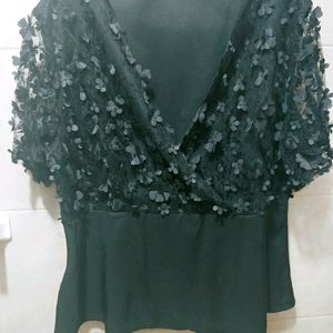 Black blouse with flower accent